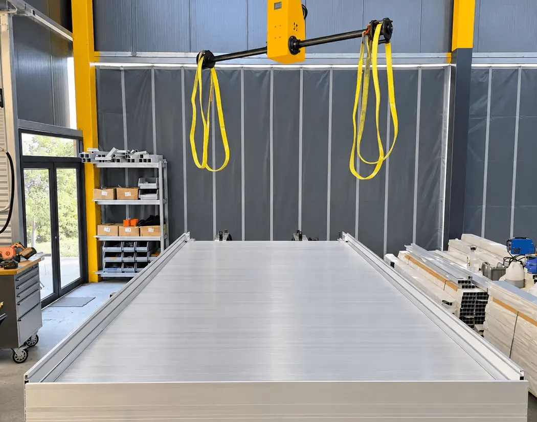Aluminium truck-body floor beneath workshop lifting equipment
